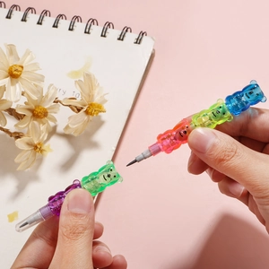 Close-up of hand assembling colorful bear-shaped stacking pencil on creative workspace