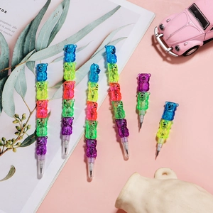Detail of colorful teddy bear stacking pencils on a playful pink desk setting