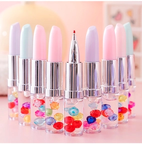 Detail of creative lipstick-shaped gel pens featuring colorful quicksand beads in clear tubes