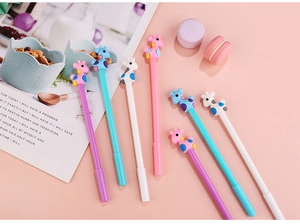 Detail of 7pcs cartoon giraffe gel pens set with soft silicone toppers on pink background