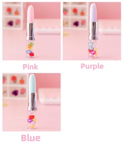 Detailed view of lipstick-shaped pens with colorful floating beads in clear bases