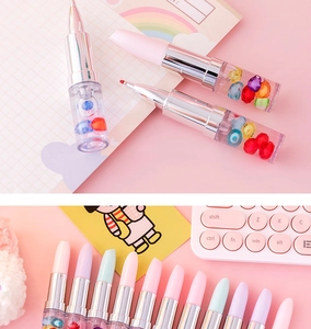 Macro detail of creative lipstick-shaped highlighter with transparent barrel and beads