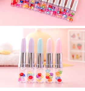 Detail of lipstick-shaped gel pen featuring macaron colors and colorful glitter beads