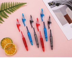 Close-up of assorted retractable gel pens with ergonomic grips on a decorative desktop