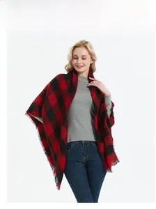 Detail of red and black buffalo plaid scarf with soft fringe edges and elegant drape