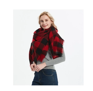 Close-up of red and black buffalo check scarf with soft fringe edges for winter