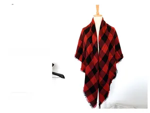 Close-up of red and black checkered cashmere-like scarf with fringe detail on a mannequin