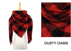 Detail of red and black buffalo plaid scarf with frayed tassels and cashmere texture