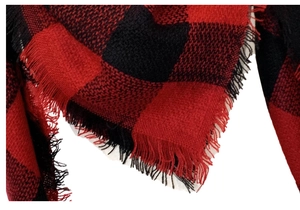 Detail of red and black checkered cashmere-feel scarf with fine fringe edges