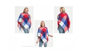 Detail of red and blue checkered knit poncho featuring long tassel trim and thick texture