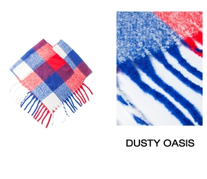 Detail of red white and blue plaid knit shawl featuring long twisted tassels and soft texture