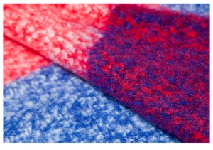 Macro detail of thick knit poncho with soft mohair fibers and red blue color block