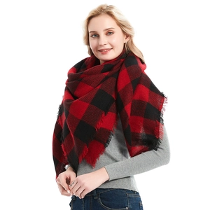Soft red and black buffalo plaid cashmere shawl scarf with fringes worn by a model
