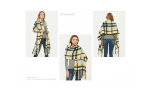Macro detail of the thick oversized yellow and navy blue plaid scarf with long tassels