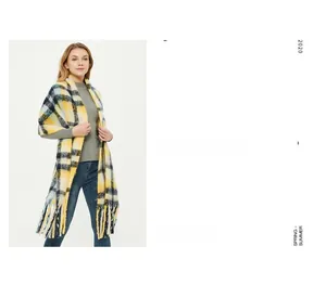 Detail of checkered tassel scarf with vibrant yellow and navy blue wool-like texture