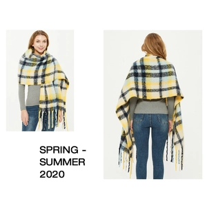 Detail of yellow and blue plaid scarf showing soft mohair-like texture and fringe tassels