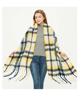 Close-up of thick yellow and navy plaid scarf with soft fringe details for winter