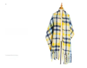 Close-up of yellow and navy blue plaid scarf with thick fringe and mohair texture