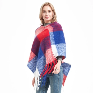 Plaid knitted poncho cape with oversized fringe in red blue and white colors