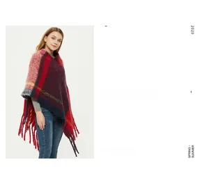 Close-up of thick checkered knit poncho with long tassels in red and navy colors
