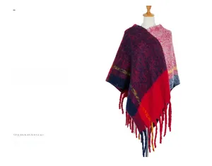 Detailed knit texture of a thick color-block poncho featuring fringe and yellow stripes
