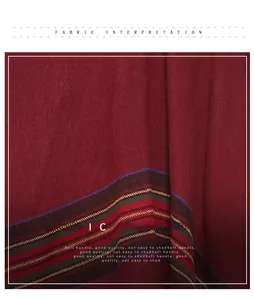 Close-up of red twill fabric detail with colorful striped edges and soft texture