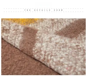 Close-up of thick knit poncho fabric showing soft texture and color block pattern
