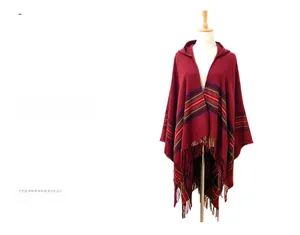 Detail of burgundy hooded poncho with colorful stripes, fringe trim, and thick knit texture