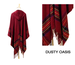 Detail of red hooded poncho with ethnic stripes, thick knit fabric and long fringes