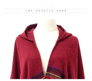 Detail of the hooded neckline and dark red knit texture of the vintage poncho cape