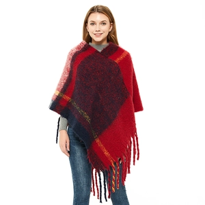 Plaid knitted poncho for women with fringe trim and oversized red and blue check pattern
