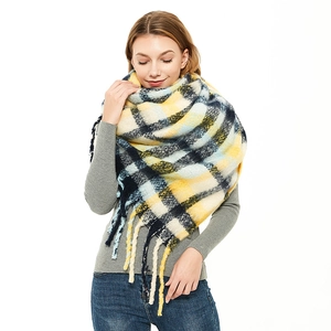 Oversized plaid scarf with thick tassels and mohair-like texture on female model