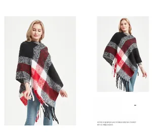 Détail d'un poncho à carreaux pour femmes avec de longues franges et une texture tricotée