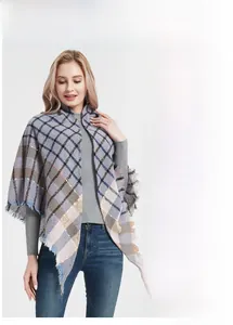 Detail view of plaid triangle scarf with fringe edges and premium soft knit texture