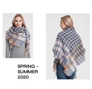 Detail of multi-color plaid shawl scarf featuring soft fabric texture and fringe edges