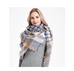 Detailed view of thick plaid shawl featuring colorful sequins and fringe trim details
