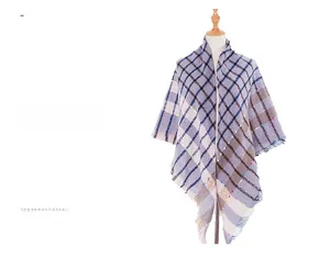 Detail of plaid scarf with fringe edges in blue and grey tones and colorful specks