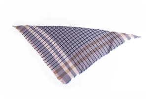 Macro detail of plaid triangle scarf showing woven texture and fringe edges