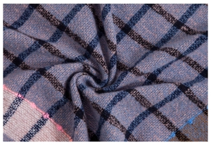 Close-up macro detail of the plaid knit scarf showing soft purple and blue woven fibers