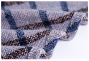 Detailed macro shot of blue and black plaid scarf with fluffy woven texture