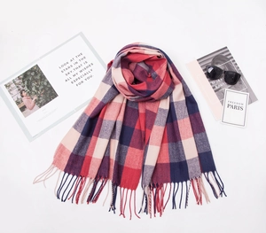 Classic red and navy plaid tassel scarf displayed with sunglasses and magazine