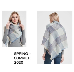 Close-up detail of oversized plaid shawl with colorful polka dots and fringe edges