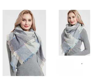 Detail of grey-blue plaid scarf with colorful dots and natural fringe texture