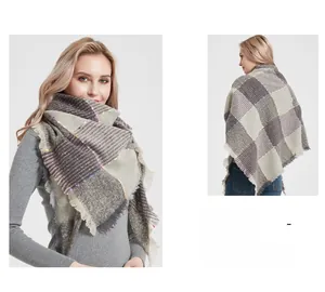 Detail of grey and white plaid scarf featuring decorative colorful pom-pom trim and tassels