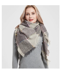 Detail view of colorful neps on thick grey plaid scarf with soft fringed edges