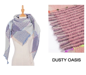 Close-up of thick plaid knit scarf featuring vibrant neon yarn accents and fringe details