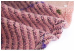 Macro shot of fluffy brushed knit fabric with colorful pink and purple striped texture