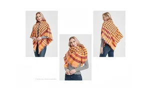 Detailed view of the bright orange and blue checkered thick shawl with fringed edges