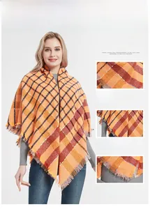 Detail of orange plaid scarf showing soft brushed texture and delicate tassel fringe