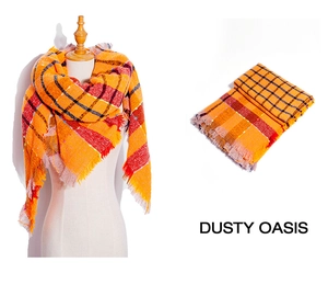 Detail view of thick orange plaid scarf with fringe and soft textured fabric texture